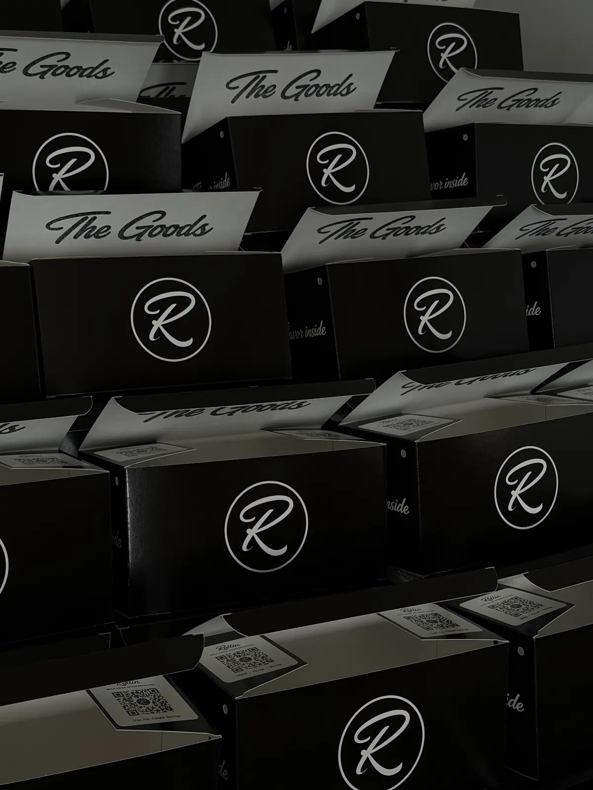 Rollin Asian fusion takeout boxes and sushi spread arranged on a dark background