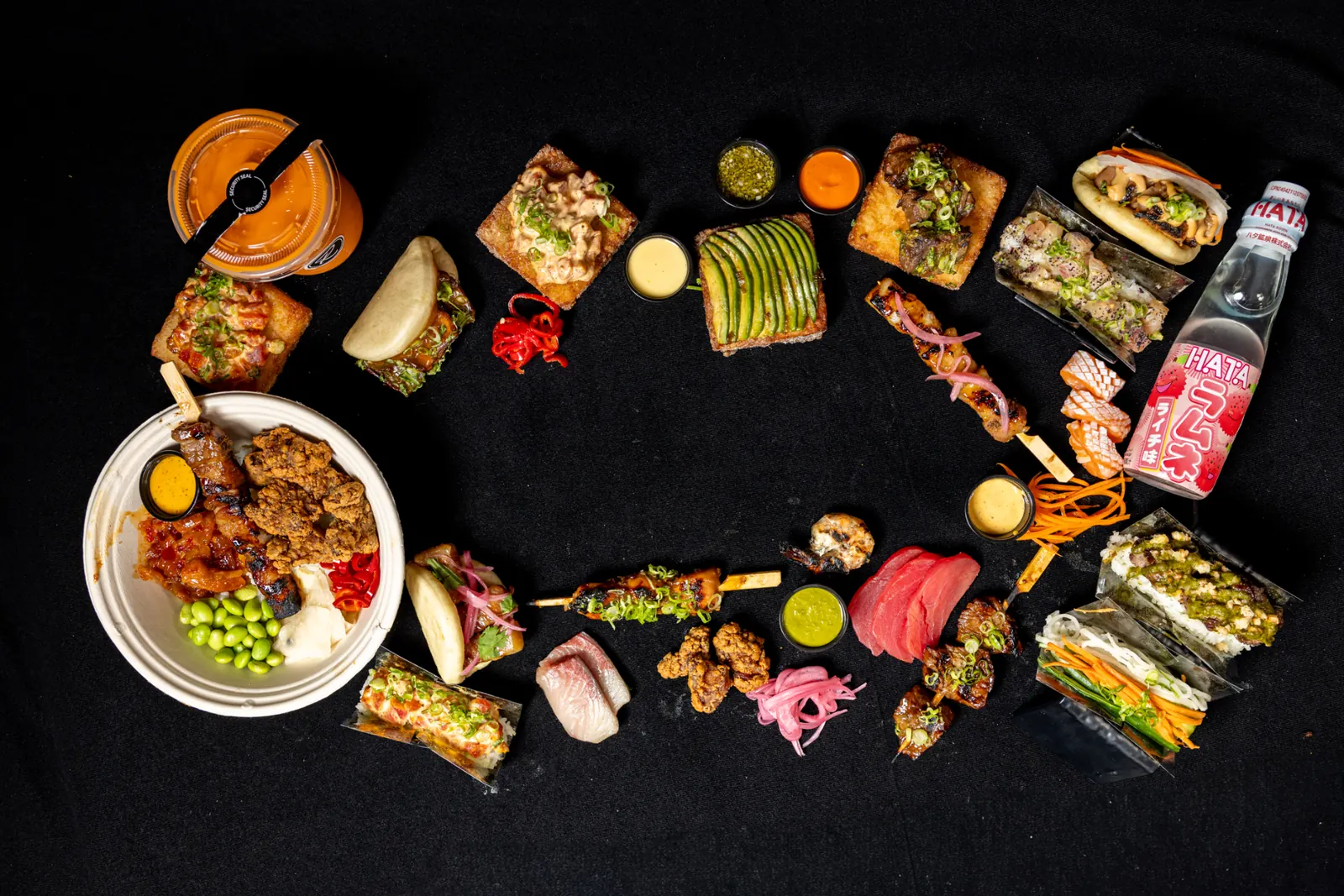 Ring of Rollin sushi rolls, bao and drinks photographed from above